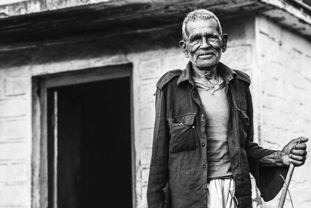 Studio portrait of a smiling Swiss senior man with glasses