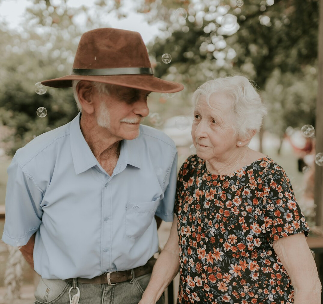 happy elderly couple gardening