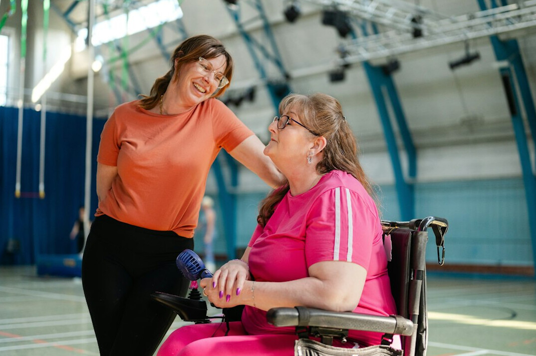Senior woman learning to use a tablet with a young instructor