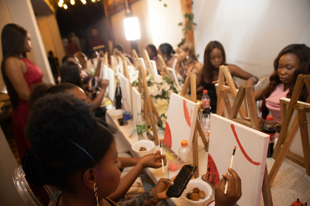 Group of seniors painting together in an art workshop