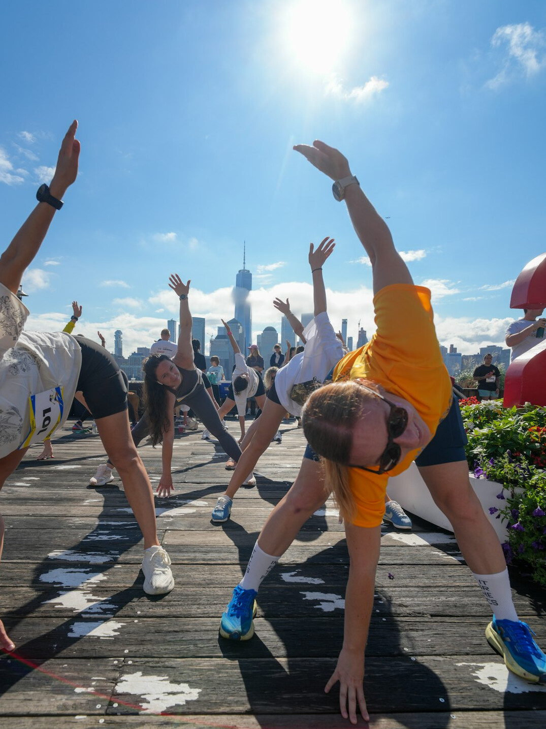 Diverse group of active seniors laughing and stretching together outdoors